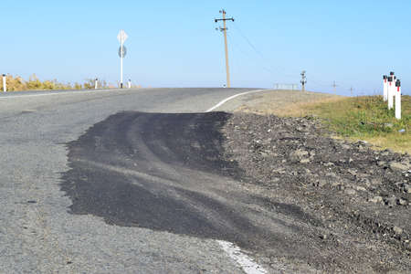 Repair of an asphalt road surfacing. A patch on asphalt.の写真素材
