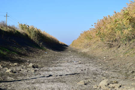 The dried-up channel of an irrigation system of rice. Agricultural constructions.の写真素材