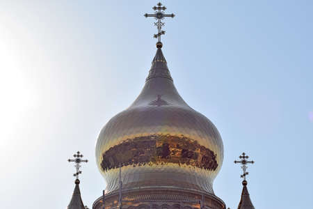 Domes of an Orthodox church. Gold-plated dome, orthodox crosses and blue roof.の写真素材
