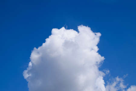 Bright midday blue sky with clouds. Heavenly landscape.