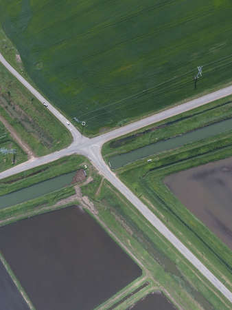 Crossroads paved roads through the fields. View from above.