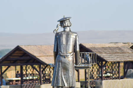 Statue of a furrier from metal with a rat in a cage. Metal statue.の写真素材