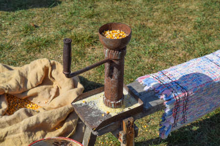 Manual Corncrusher corn grinding. Milling of different grains by hand in the old days.の写真素材