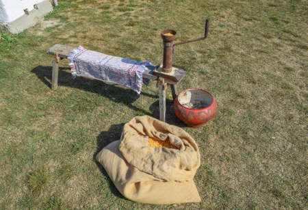 Manual Corncrusher corn grinding. Milling of different grains by hand in the old days.の写真素材