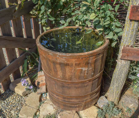 Wooden barrel filled with water. Storage in open water outdoors container.の写真素材