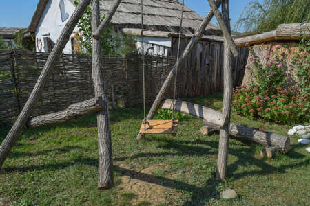 Homemade swing in the yard. The logs and rope swing at the heart of the design.の写真素材