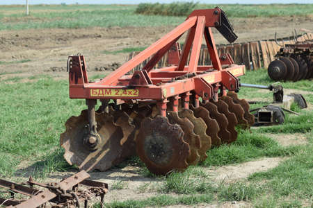 The disk harrow. Agricultural machinery for processing of the soil in the field.の写真素材