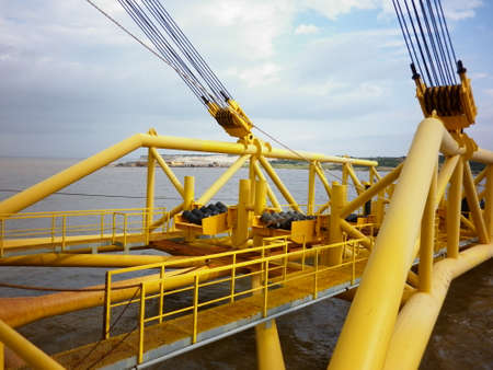 Deck pipe-laying vessel. pipes, valves and other equipment on the deck.
