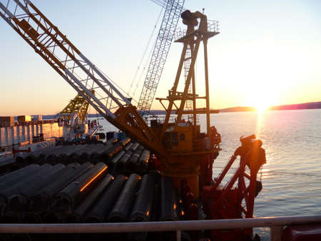 Deck pipe-laying vessel. pipes, valves and other equipment on the deck.の写真素材