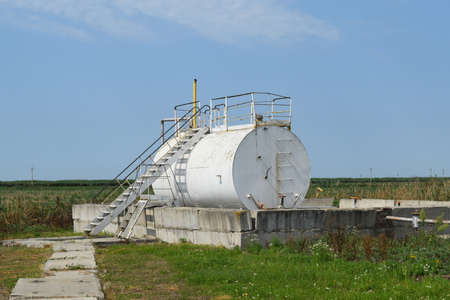 Barrel of oil separation. The equipment in the oil fields. Pipes, pumps and units.の写真素材