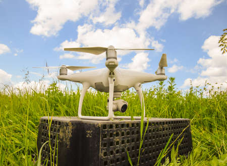 Quadrocopters on a plastic box in the grass. Preparation quadrocopter to fly.