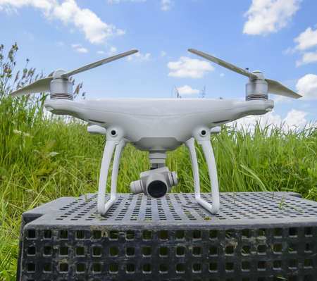 Quadrocopters on a plastic box in the grass. Preparation quadrocopter to fly.の写真素材