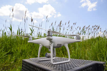 Quadrocopters on a plastic box in the grass. Preparation quadrocopter to fly.