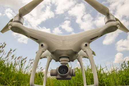 Russia, Poltavskaya village - May 1, 2016: Quadrocopters on a plastic box in the grass. Preparation quadrocopter to fly.のeditorial素材