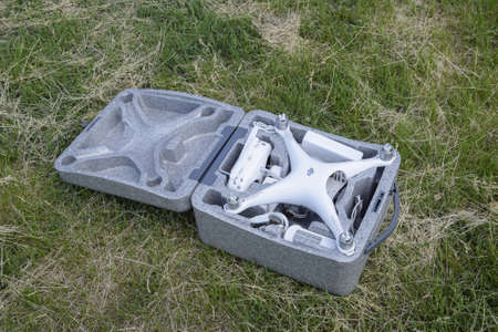 Russia, Poltavskaya village - May 13, 2016: Open case with quadrocopters DJI Phantom 4. The opening of the box on the lawn.のeditorial素材