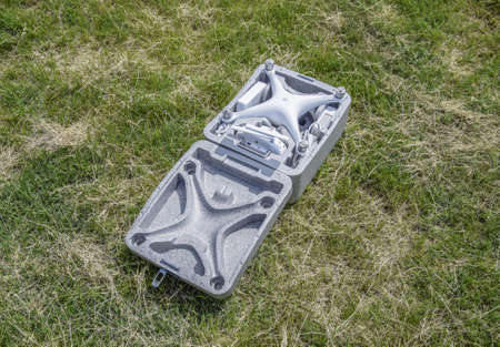 Russia, Poltavskaya village - May 13, 2016: Open case with quadrocopters DJI Phantom 4. The opening of the box on the lawn.のeditorial素材
