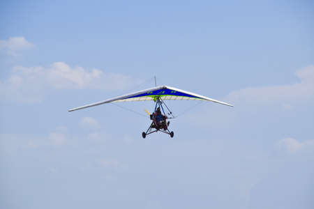 Russia, Veselovka - September 6, 2016: Trike, flying in the sky with two people. Extreme...