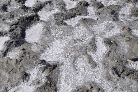 The crust of salt on the bottom of the curative mud dry lake. The surface of the salt lake.の写真素材