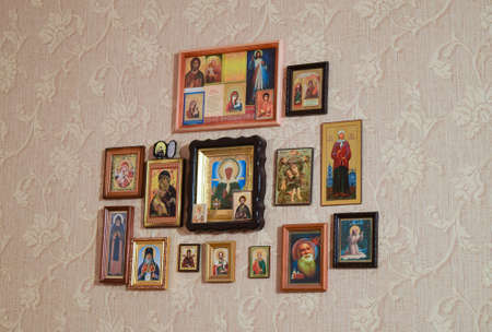 Russia, Poltavskaya village - 31 December 2015: Orthodox Christian icons on the wall, glued wallpaper.のeditorial素材