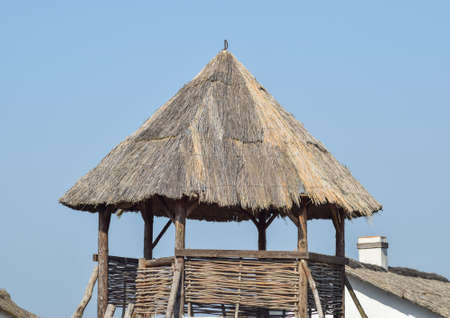 Watchtower with a thatched roof. Wooden observation tower.の写真素材