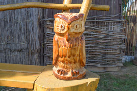 Owl carved from wood. Woodcarving. Beautiful owl figurine of logs.の写真素材
