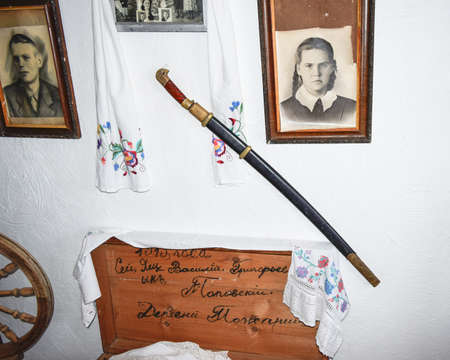 Ataman, Russia - September 26, 2015: Interior Cossack home. A wall with pictures of relatives and nominal saberのeditorial素材