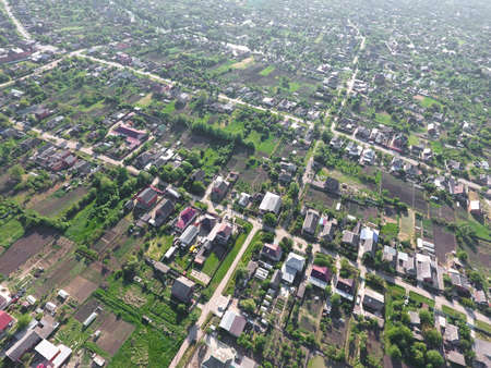 Top view of the village. One can see the roofs of the houses and gardens. Road and water in the village. Village bird's-eye view.の写真素材