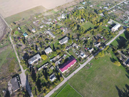 Top view of the village. One can see the roofs of the houses and gardens. Road the village. Village bird's-eye view.の写真素材
