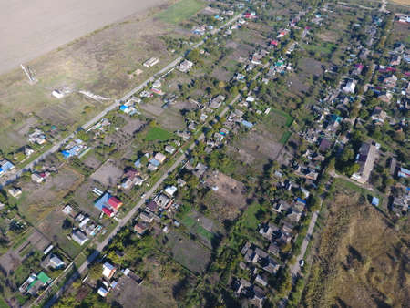 Top view of the village. One can see the roofs of the houses and gardens. Road the village. Village bird's-eye view.の写真素材