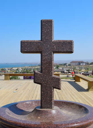 Orthodox cross made of granite near the chapel.の写真素材