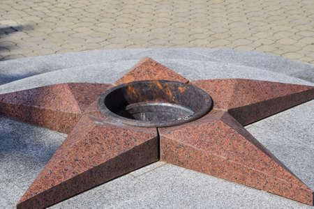 Burning of eternal fire. Five-pointed star made of granite memorial to the memory of killed soldiers.の写真素材
