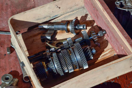 Dismantled box car transmissions. The gears on the shaft of a mechanical transmission.