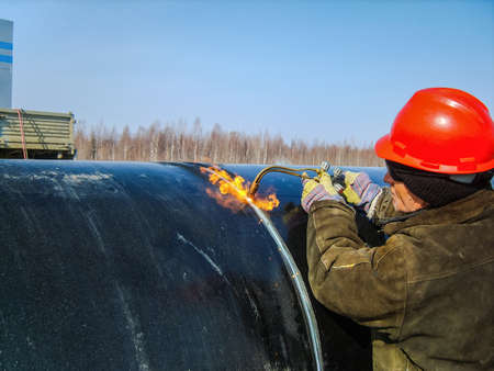 Safety at work. Welding and installation of the pipeline. Industrial weekdays welders and fitters.の写真素材