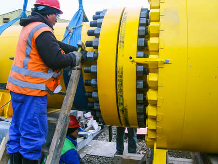 Work tighten the nuts on the flange.の写真素材