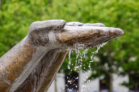 Hands statue from which water flows. Monument decoration on the fountain.の写真素材