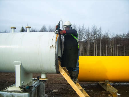 Safety at work. Welding and grinding of iron constructions. Industrial weekdays welders and fitters.の写真素材
