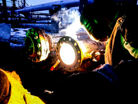 Safety at work. Welding and grinding of iron constructions. Industrial weekdays welders and fitters.の写真素材