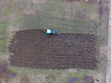 Tractor plowing the garden. Plowing the soil in the garden.
