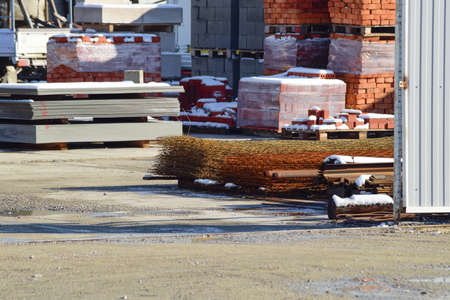 Warehouse of different materials. Wood and iron pipes and bricks.の写真素材