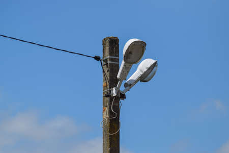 Lanterns on the pole. A pillar of power line with lighting fixtures.の写真素材