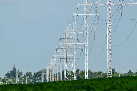 Transmission tower on a background field of soybeans.