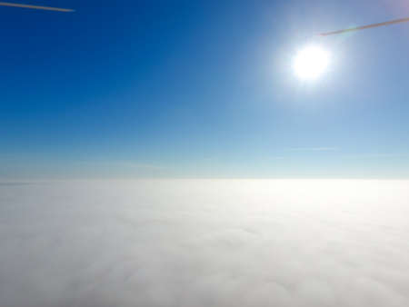 In the skies above the fog. Sunrise over the fog. Clouds near the ground.の写真素材