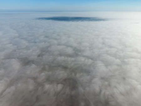 In the skies above the fog. Sunrise over the fog. Clouds near the ground.の写真素材