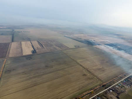 Burning straw in the fields after harvesting wheat cropの写真素材
