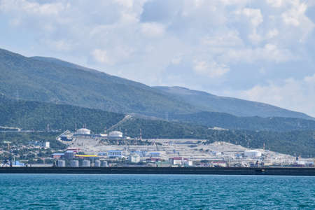 international seaports. Cargo port with port cranes. Sea bay and mountainous coast.の写真素材