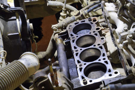 The cylinder block of the four-cylinder engine. Disassembled motor vehicle for repair. Parts in...