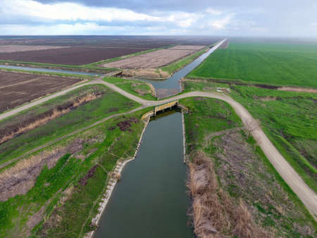 Bridges through irrigation canals. Rice field irrigation system.の写真素材