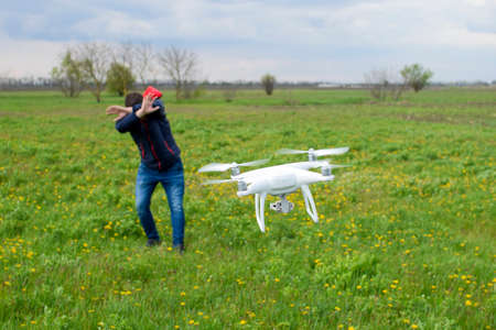 A man hides himself from a collision with a drone. Quadrocopter flies to the person.