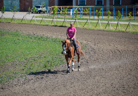 Krasnodar, Russia - April 28, 2017: Equestrian sports with teenagers. Horse Club. A girl is riding a horse.のeditorial素材