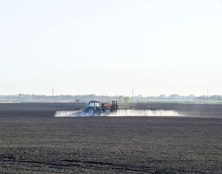 The tractor sprayed herbicides on the field. Chemistry in agriculture.の写真素材